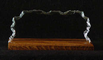 Chipped glass sample on wood base